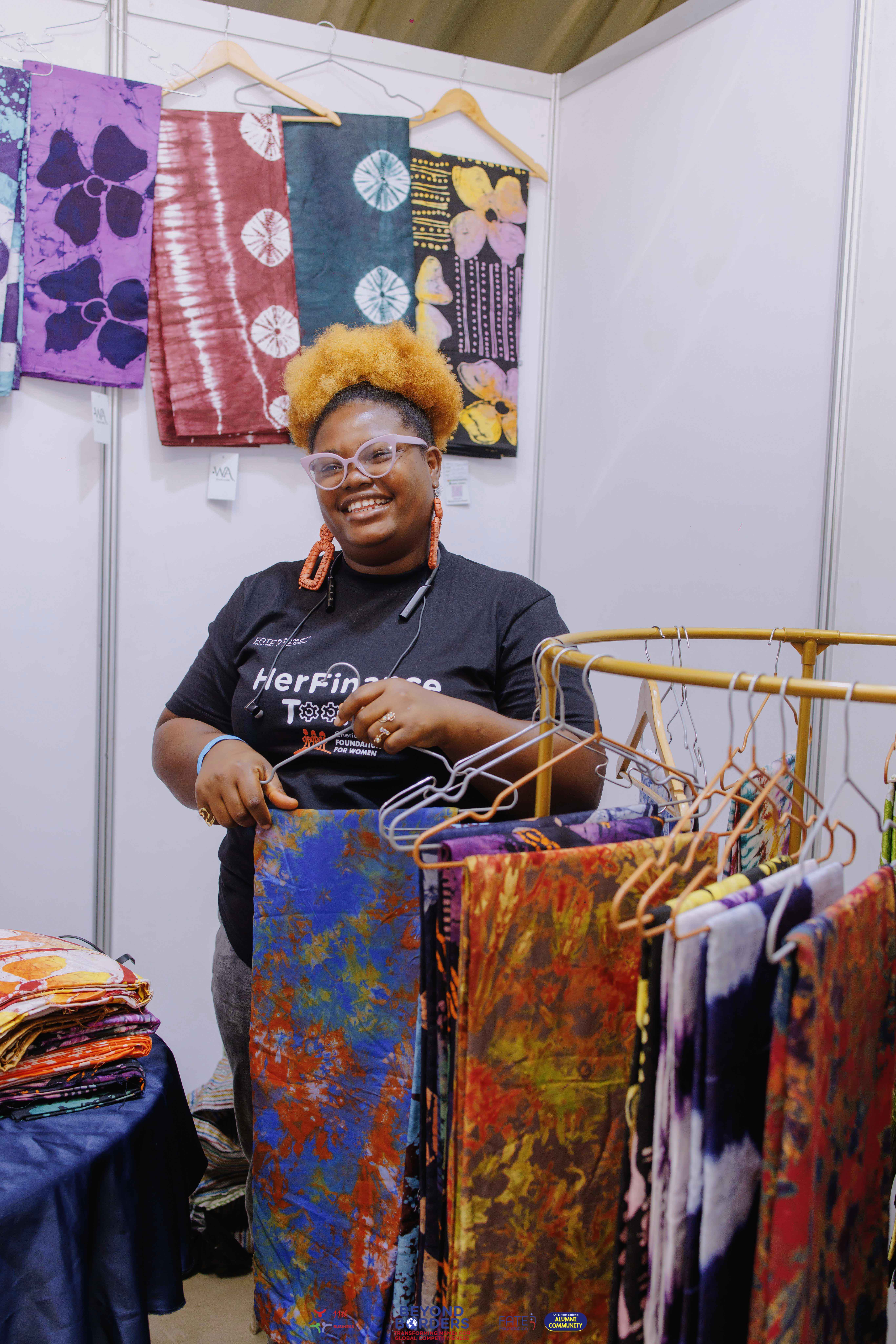 Entrepreneur wearing a HerFinance-branded shirt at the conference